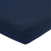 Close-up of a navy blue textured fabric cushion corner with a clean white background. 