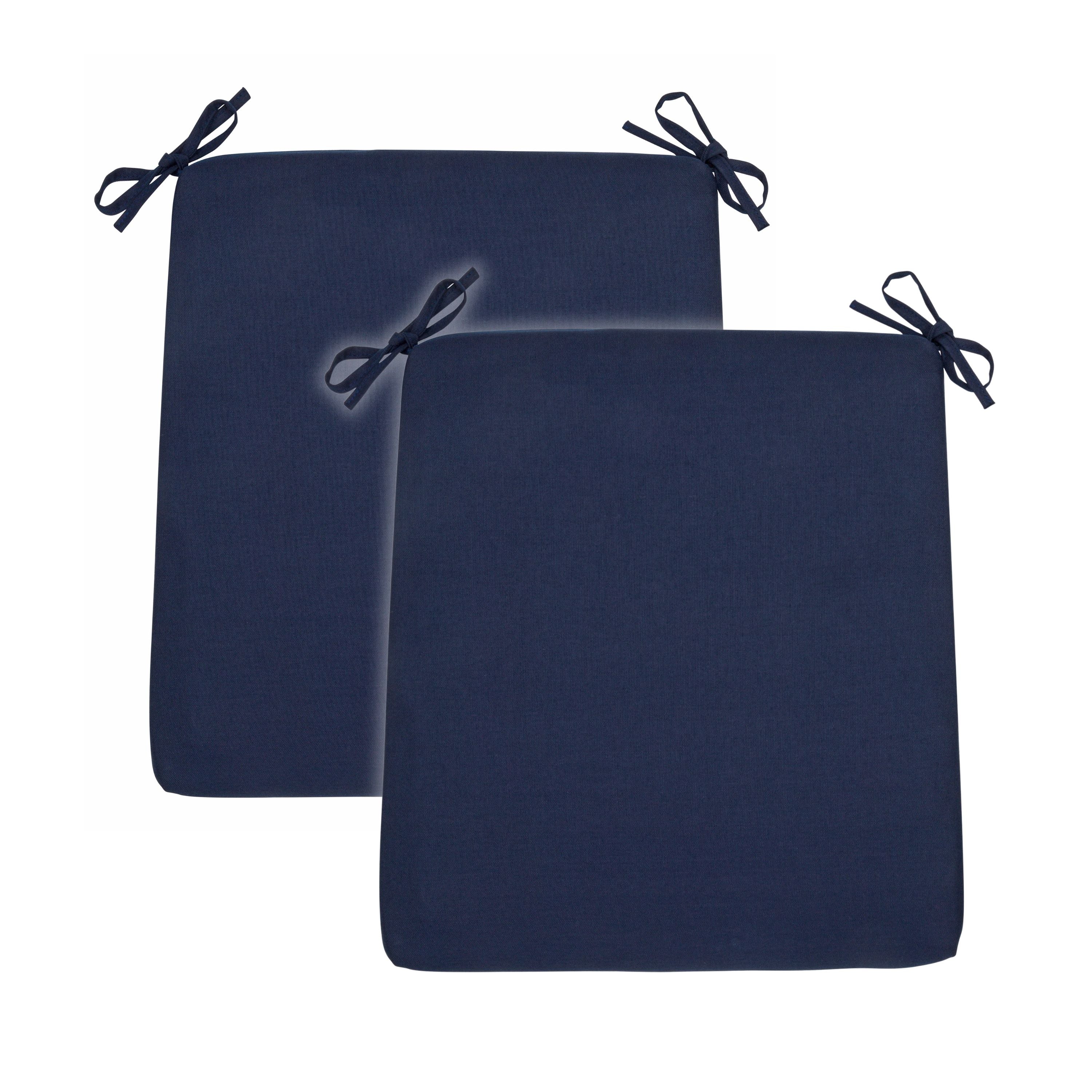 Two navy blue rectangular outdoor seat cushions with black tie-down straps, shown overlapping on a plain white background. 