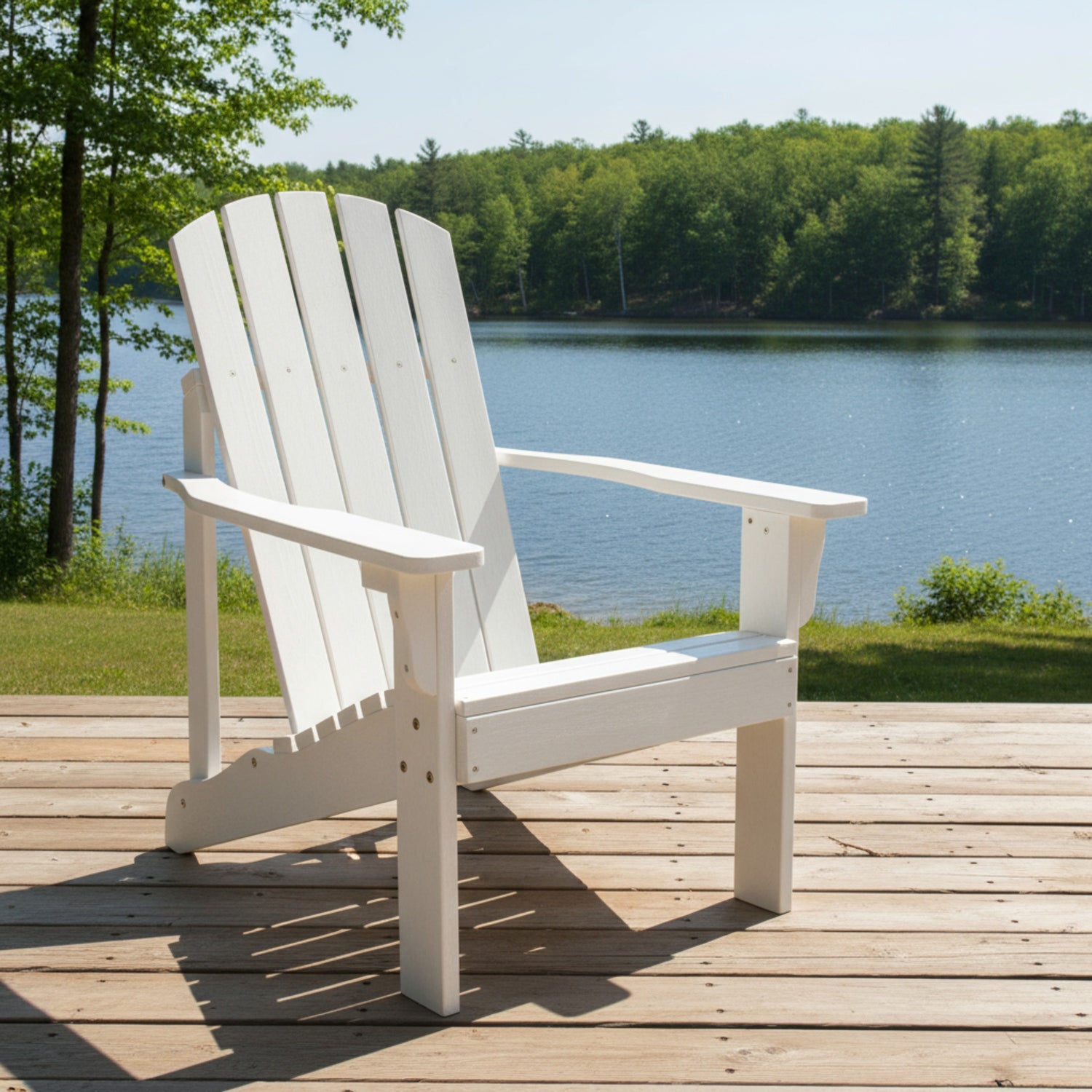 White Adirondack chair on a wooden deck by a lake with trees in the background 