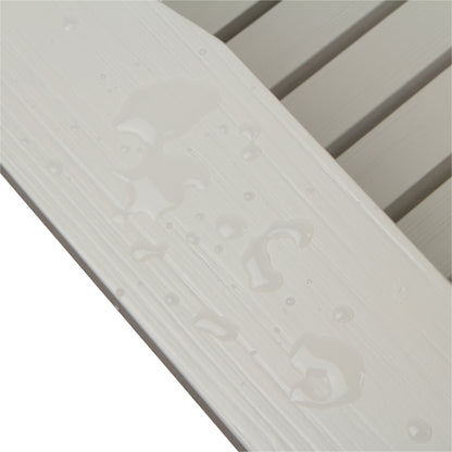 Close-up of a white textured slatted surface with water droplets on a white background. 
