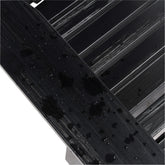 Close-up of a glossy black textured wooden slat surface showing the water resistant paint quality against a white background with diagonal black bars. 