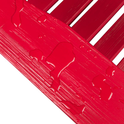 A close-up of a glossy red painted wooden slat surface with water droplets running down the textured finish, set against a white background. 