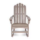 A single Adirondack-style rocking chair in a light weathered gray-brown finish, shown from the front against a plain white background. 