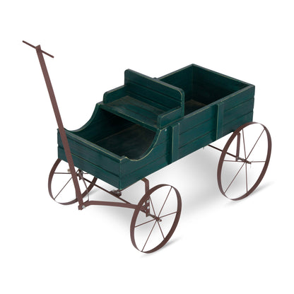 A vintage-style metal wagon toy or decorative cart with a dark green wooden cargo bed and a rusted brown metal frame, handle, and spoked wheels, shown on a white background. 