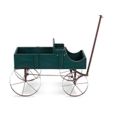 A vintage-style wooden carriage or pram with a dark green painted body and a brown metal frame, including four spoked wheels and a long handle, shown on a plain white background. 