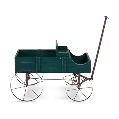 A vintage-style wooden carriage or pram with a dark green painted body and a brown metal frame, including four spoked wheels and a long handle, shown on a plain white background. 