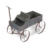 A rustic decorative wooden wagon planter with a dark gray weathered wood body and dark brown metal wheels and handle, shown on a white background.  