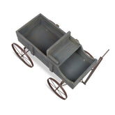 A rustic wooden wagon with a weathered gray-brown finish and dark metal wheels, shown on a plain white background.  