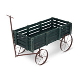A rustic wooden garden cart with a dark green slatted bed and a weathered brown metal frame with two spoked wheels and a push handle, shown on a white background. 
