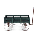 A rustic wooden wagon planter or decorative cart with a dark green painted wood body, weathered brown metal frame, and large spoked wheels, shown on a plain white background. 