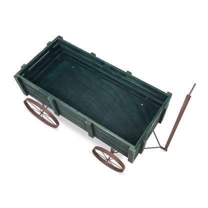 A miniature wooden wagon or cart with a dark green painted body, brown wheels, and a brown handle, shown on a plain white background. 