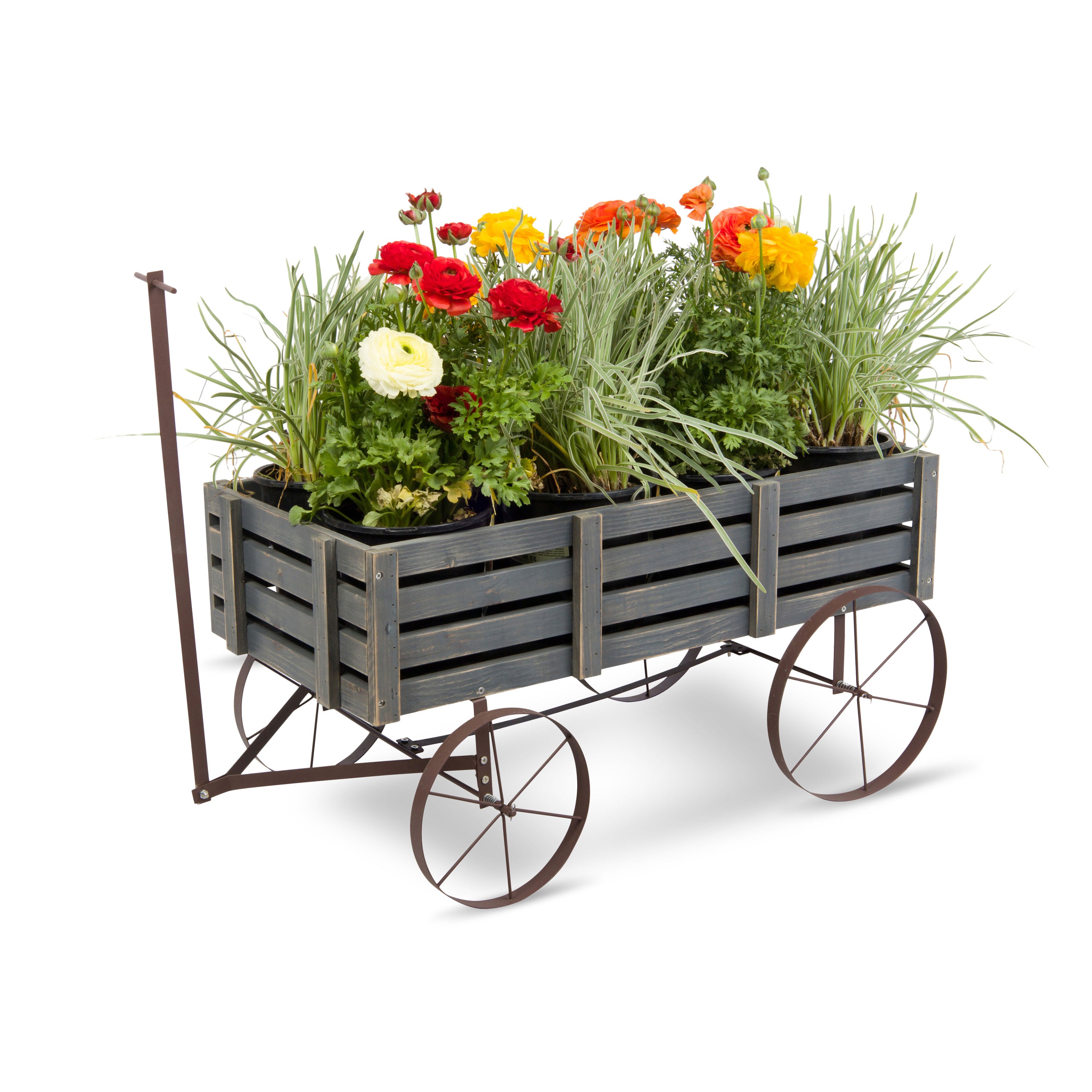 A rustic three-barnacle wagon planter with a dark gray wooden slat bed filled with colorful flowers and green grasses, shown on a white background. 