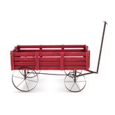 A red wooden wagon with a dark metal frame, four spoked wheels, and a tall handle, shown from the side on a white background. 