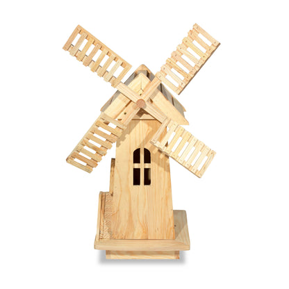 A miniature wooden windmill decoration made from light natural wood, featuring four slatted blades and a small arched window on the tower, shown against a plain white background. 