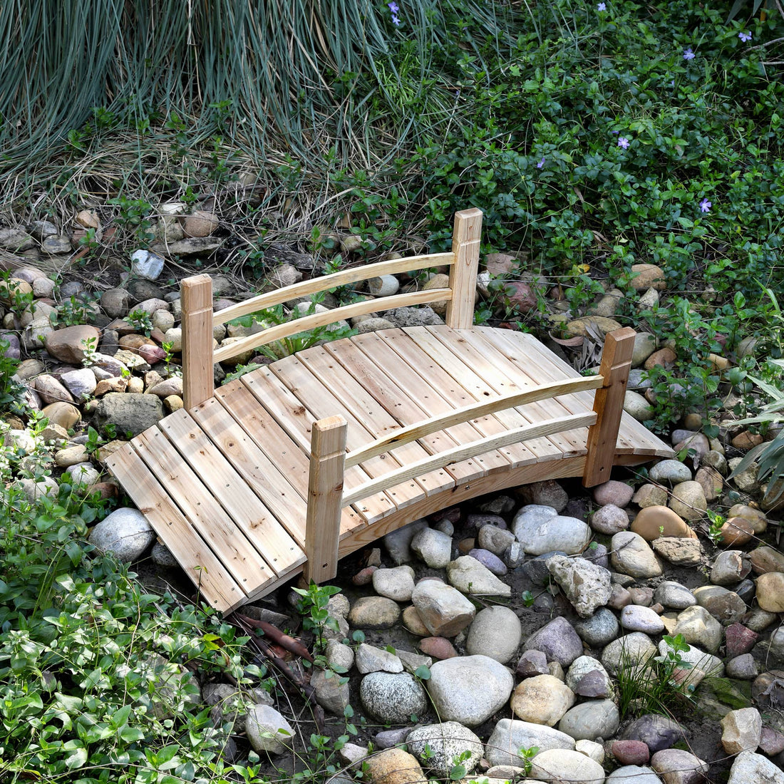 4ft wooden garden bridge over a bed of stones and plants 