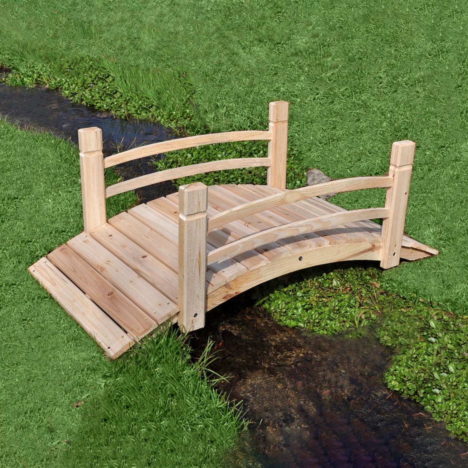 A small 4ft arched wooden garden bridge with railings, shown spanning a narrow stream on a green grassy lawn. 