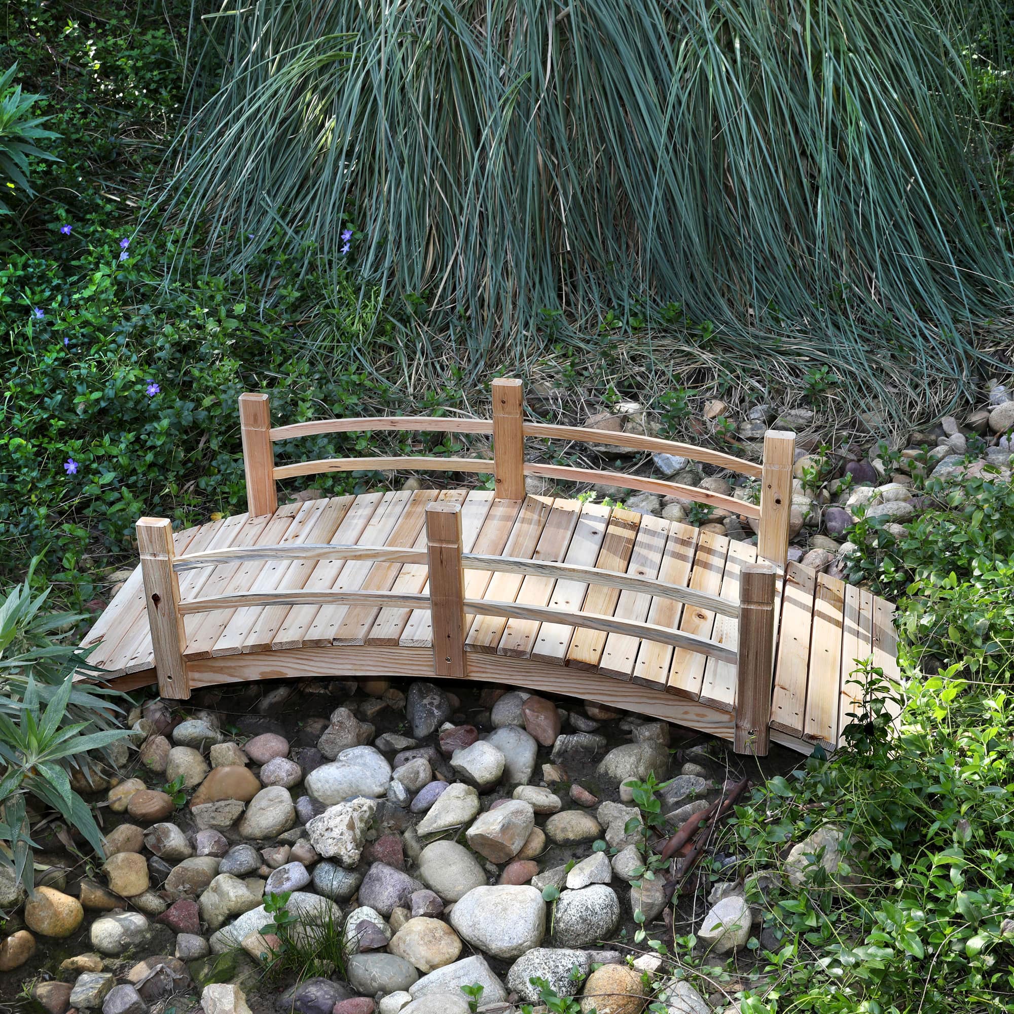 6ft Wooden garden bridge over a small stream with greenery around 