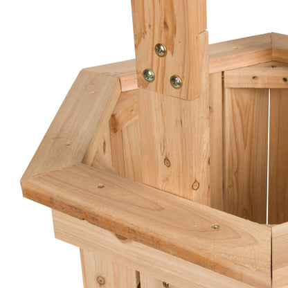 Close-up of a light natural wood structure, showing a house-shaped frame with a vertical post, horizontal beams, and metal fasteners on a white background. 