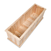 A rectangular wooden planter box made from light natural wood planks, shown from an elevated angle on a plain white background.  