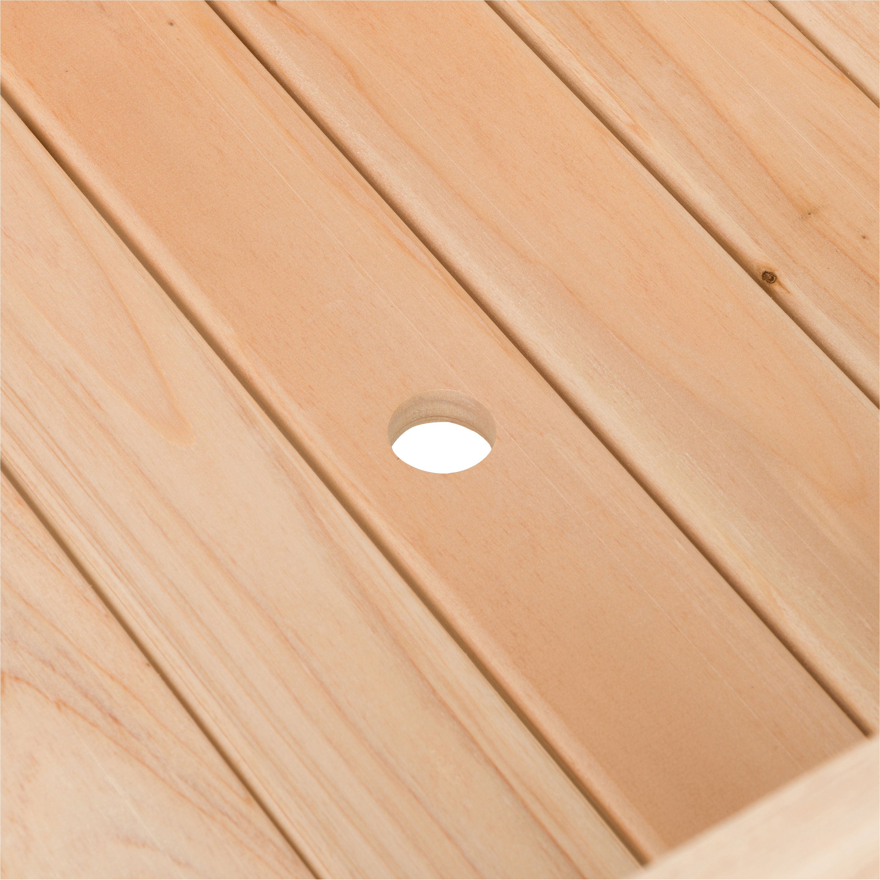 Close-up of a light natural wood slatted surface with a small circular cutout near the center. 