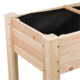 Close-up of a wooden raised garden bed with natural pine slats and a black fabric liner, shown on a white background. 