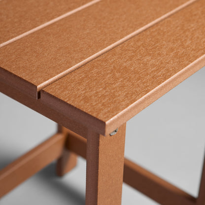 Close-up of a wooden table with a light brown finish on a white background 