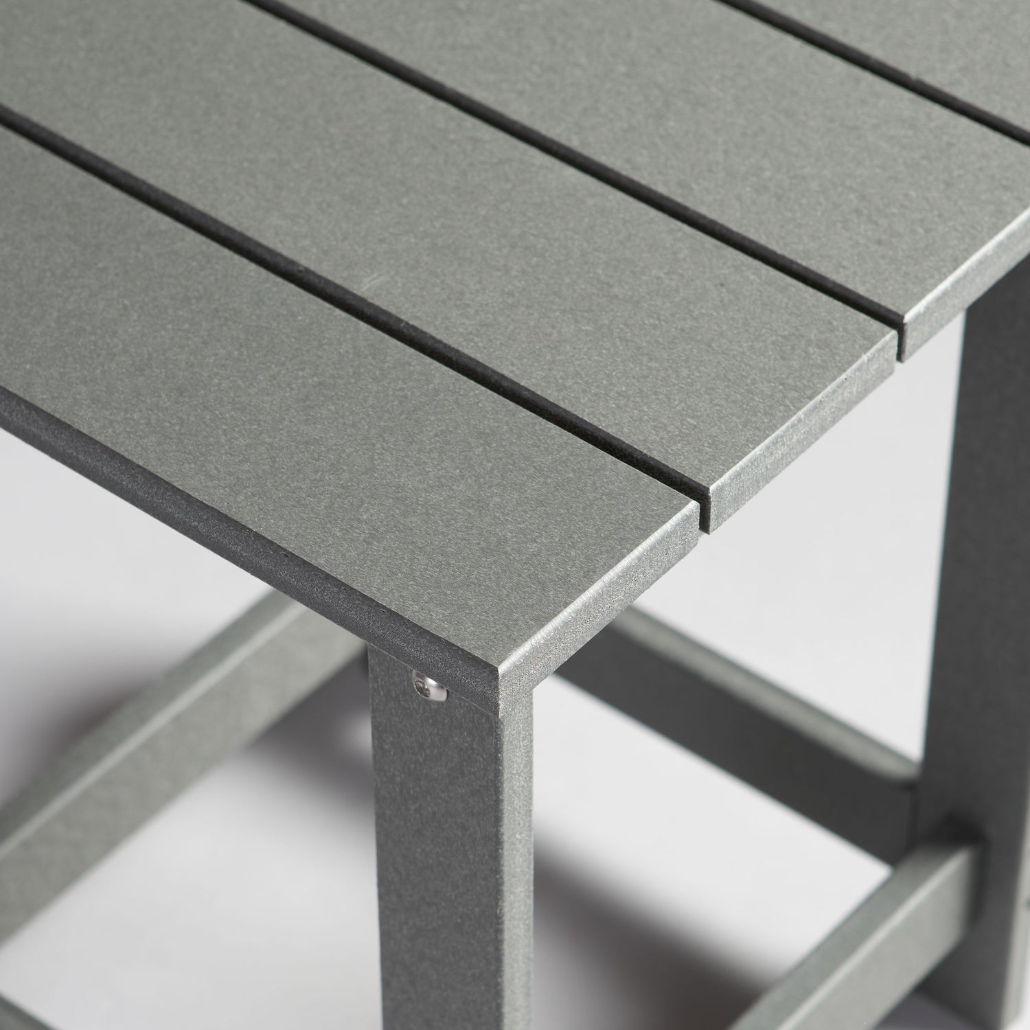 Close-up of a gray outdoor table with a blurred background 