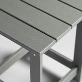 Close-up of a gray outdoor table with a blurred background 