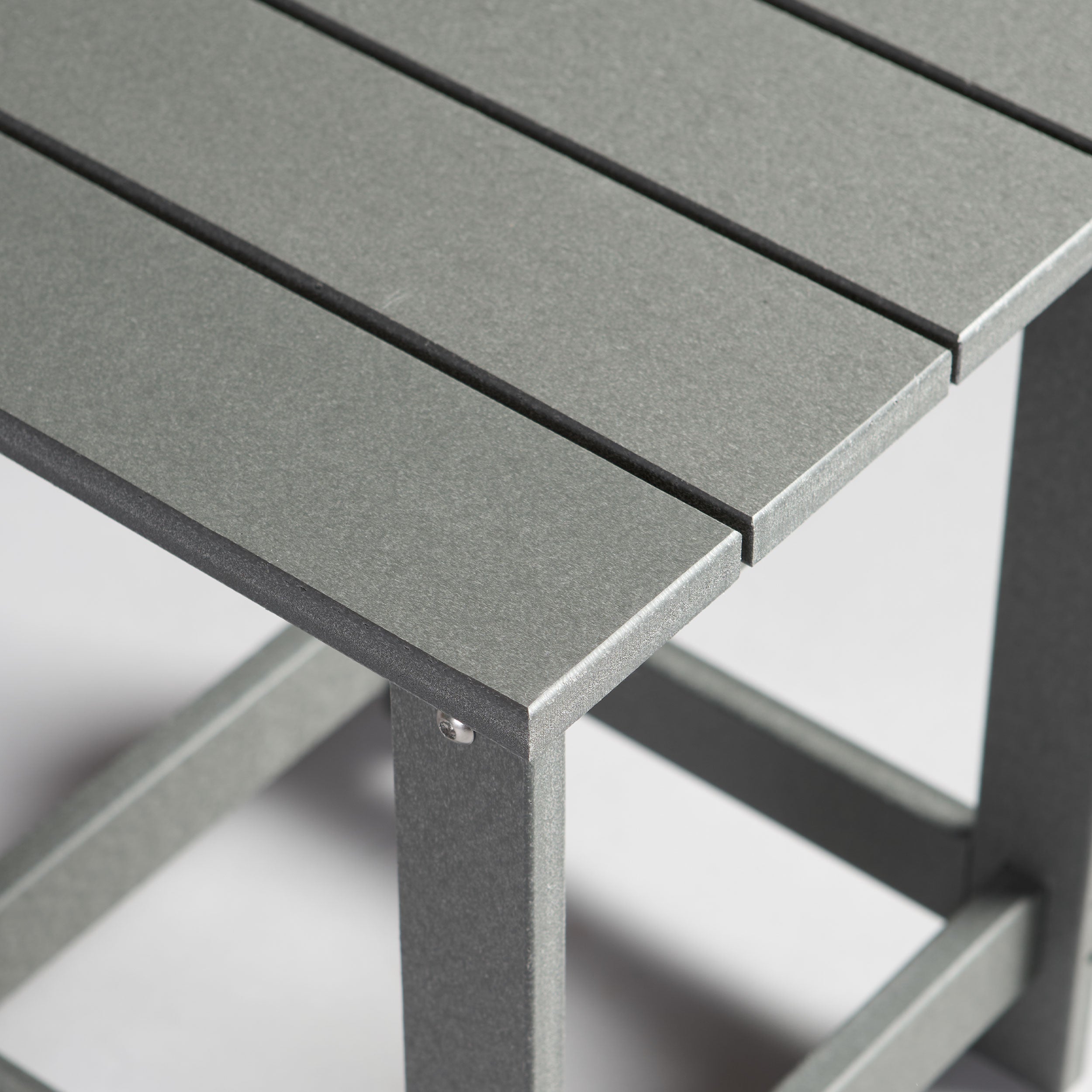 Close-up of a gray outdoor table with a blurred background 