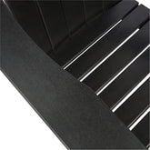 Close-up detail of a black slatted outdoor chair or bench, showing the armrest and seat slats against a white background. 