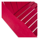 Close-up of a bright red slatted chair or bench showing the armrest and seat slats against a white background. 