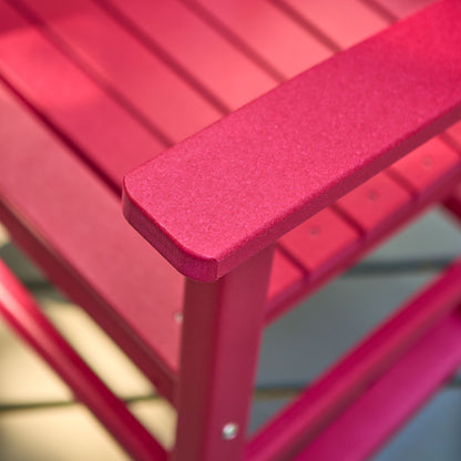 Close-up of a red slatted outdoor chair showing the armrest corner and frame construction. 