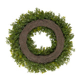 An artificial greenery wreath with dense green boxwood-style foliage and a rustic brown woven vine center, shown on a plain white background.